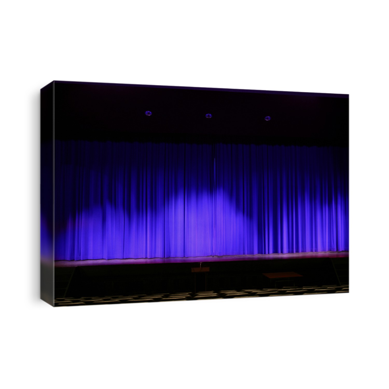 Theater stage with red velvet curtains and empty chairs in the foreground